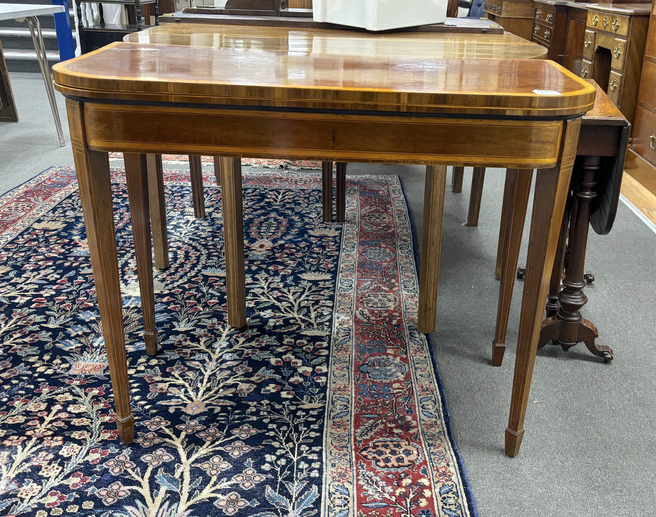 A George III satinwood banded mahogany D shape folding card table, width 94cm, depth 46cm, height 75cm